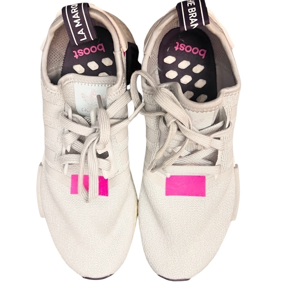 Adidas NMD_R1 pink and white trainers.